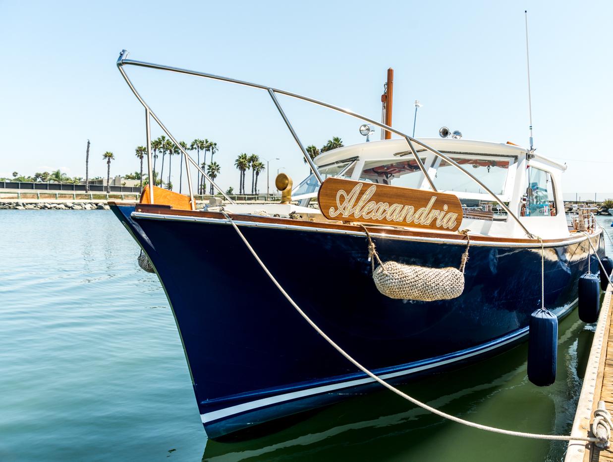 classic wooden boat docked in huntington harbour ca