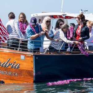 Throwing flowers into the ocean during an ash scattering memorial